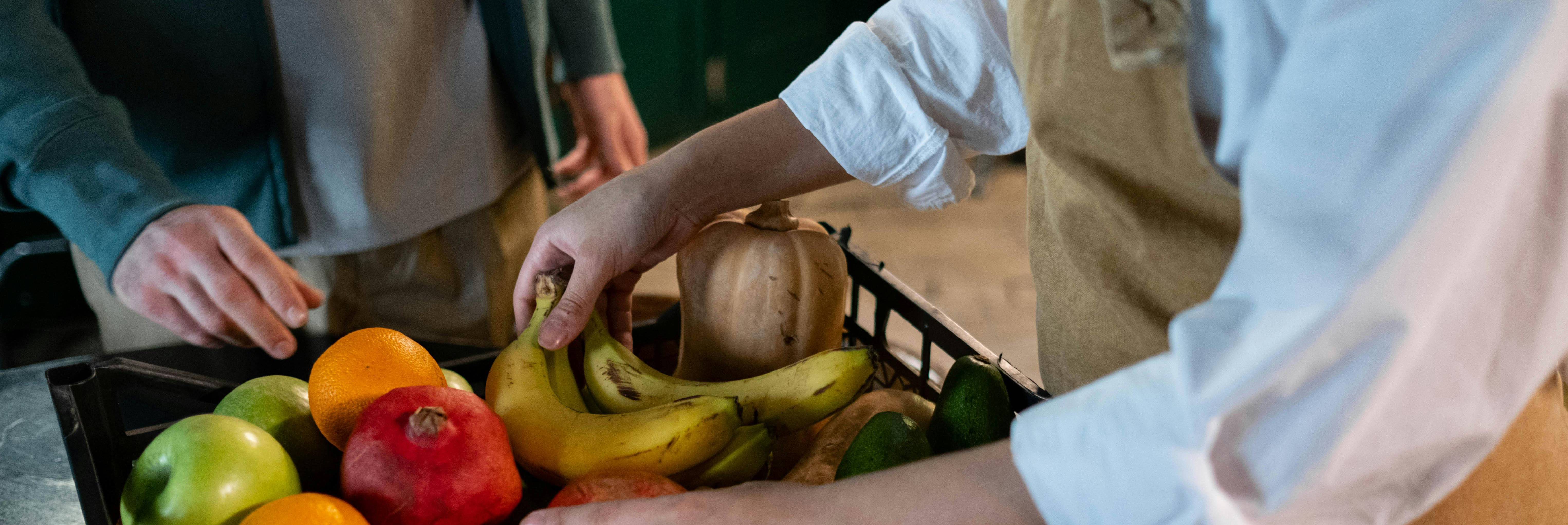 Two chefs with a crate of fresh produce